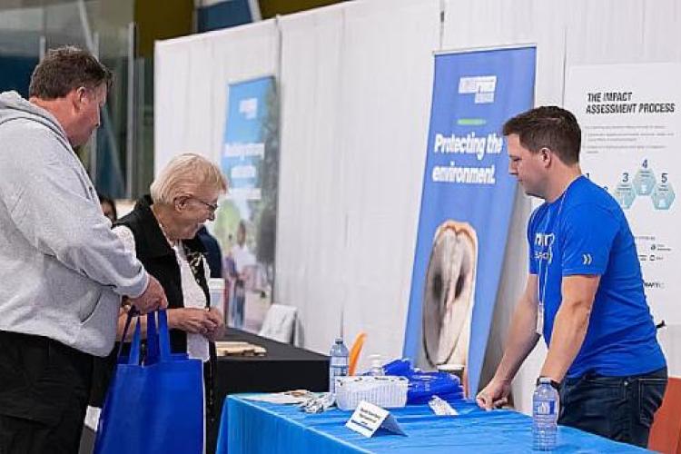 An NWMO employee explains the impact assessment process at an event